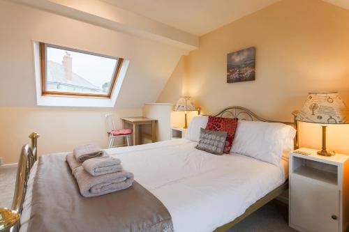 a bedroom with a bed and a window at 5 Bedroom House with Sea Views in Penryn