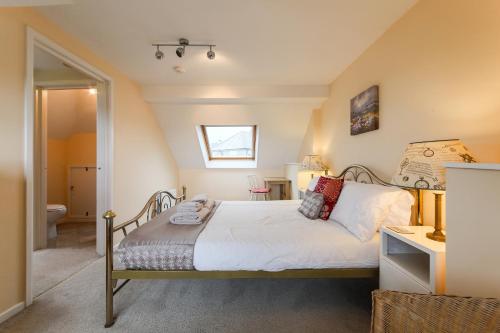 a bedroom with a bed and a bathroom at 5 Bedroom House with Sea Views in Penryn