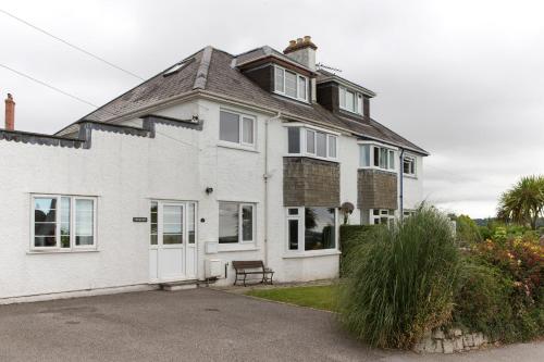 a white house with a roof at 5 Bedroom House with Sea Views in Penryn