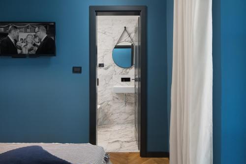 a bathroom with a mirror and a blue wall at Luxury Villa Covri in Brtonigla