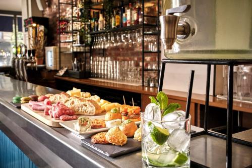 - un buffet composé de différents types de nourriture et de boissons dans l'établissement Hotel The Playce by Happyculture, à Paris