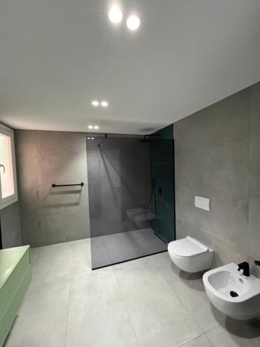 a bathroom with a shower and a toilet and a sink at Mimi's Apartment in Durrës