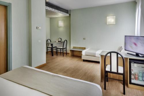 a hospital room with a bed and a television at Best Western Hotel Residence Italia in Quartu SantʼElena