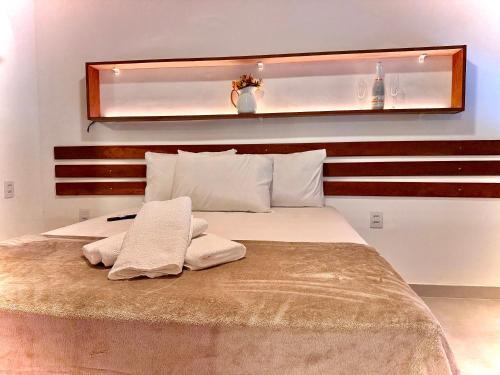 a bedroom with a bed with two towels on it at Recanto Serenare in Angra dos Reis