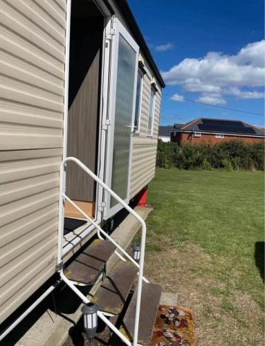 an open door on the side of a house at Miranda and Pauls Caravan in Leysdown-on-Sea