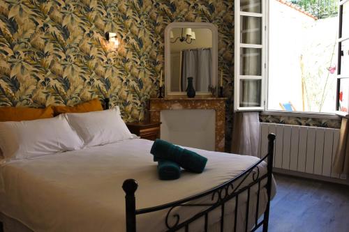 une chambre avec un lit avec un miroir au mur dans l'établissement Le Côteau du Segala, à Villefranche-de-Rouergue