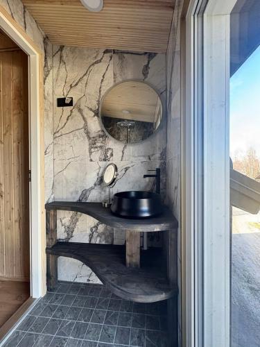 a bathroom with a sink in a stone wall at Northern lights in Inari