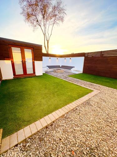 a backyard with a grass yard and a house at Beacon cottage in Skegness
