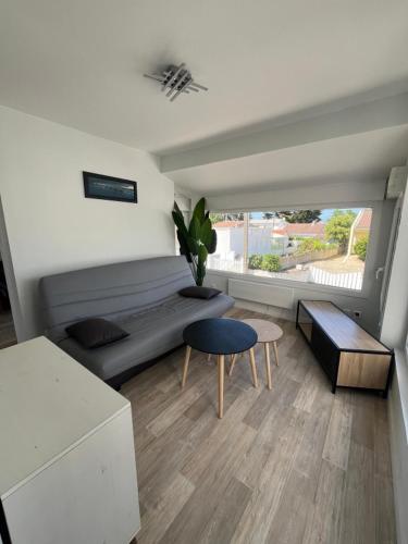 une chambre avec un lit, une table et une chaise dans l'établissement Location maison balnéaire 8 couchages 50m plage du Cormier, à La Plaine-sur-Mer
