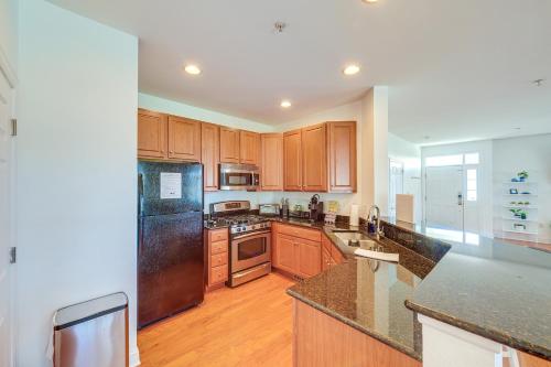 a kitchen with wooden cabinets and stainless steel appliances at 3 Mi to Beach Ocean View Getaway with Pool Access in Ocean View
