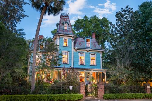 a blue house with a tower on top of it at Magnolia Plantation & Cottages in Gainesville