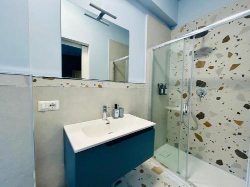 a bathroom with a sink and a shower at WelcHome Vitorchiano in Vitorchiano