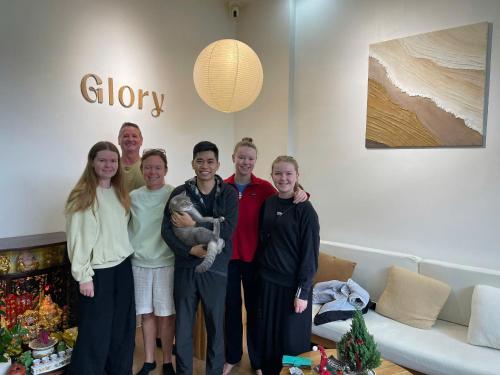 a group of people posing for a picture in a living room at Glory 2 Hue Homestay in Hue