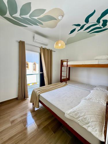 Una cama o camas en una habitación de Apartamento Ubatuba - Host Home