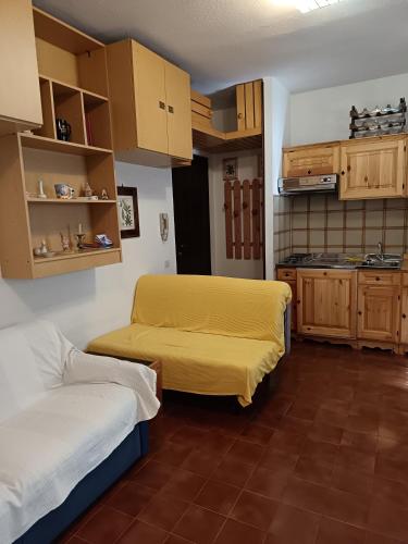 Una pequeña habitación con dos camas y una cocina. en Mono-Selene, en Scopello