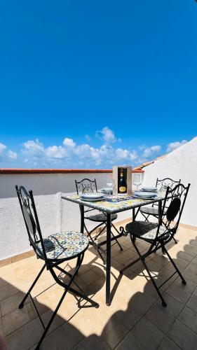 a table and two chairs on a roof at Apartment Casa Beatrice in Pizzo
