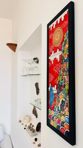 a painting hanging on a wall in a room at Apartment Casa Beatrice in Pizzo