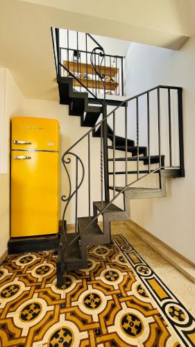a yellow door and stairs in a room with a carpet at Apartment Casa Beatrice in Pizzo