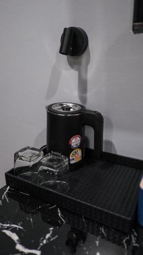 a black toaster sitting on top of a table at Lorjula INN in Hat Yai