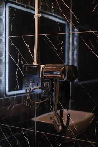 a hair dryer on a wall in a bathroom at Lorjula INN in Hat Yai