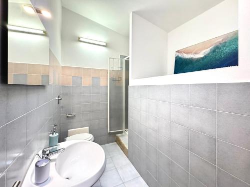 a bathroom with a sink and a toilet at Casa Proserpio in Villasimius