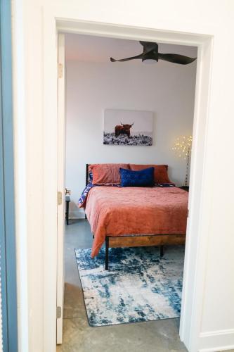 a bedroom with a bed and a ceiling fan at The Sunflower Suite in Lawrence