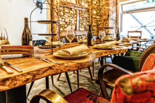 a long wooden table with wine glasses on it at Hotel-Restaurant Kostbar in Engen