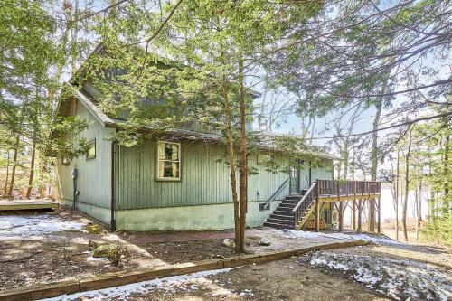 a small green house with a tree in front of it at Lakeside Getaway - Lake Access & Firepit in Wolfeboro