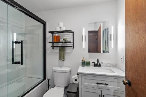 a bathroom with a shower and a toilet and a sink at Lakeside Getaway - Lake Access & Firepit in Wolfeboro