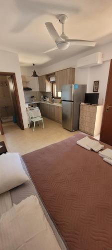a kitchen with a large bed in a room at Anemos in Tsoútsouros