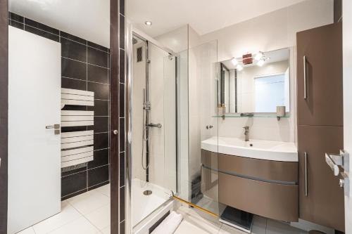 une salle de bain avec douche et lavabo dans l'établissement Latour Maubourg 20 by Halldis, à Cannes