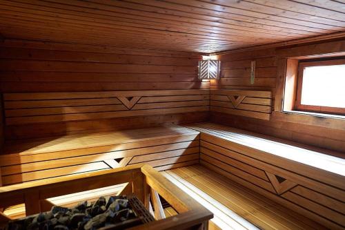 an inside of a wooden sauna with a window at Urlaub mit Sauna und Pool ist cool! in Bad Harzburg