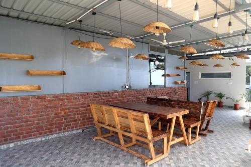 a dining room with a wooden table and chairs at ALPINE BNB Dharmshala in Dharamshala