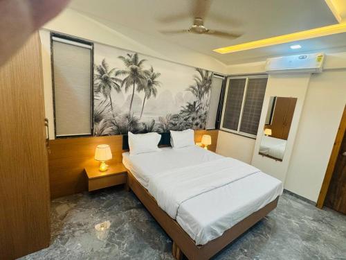 a bedroom with a large white bed with two lamps at Hotel Mighter Crest in Nashik