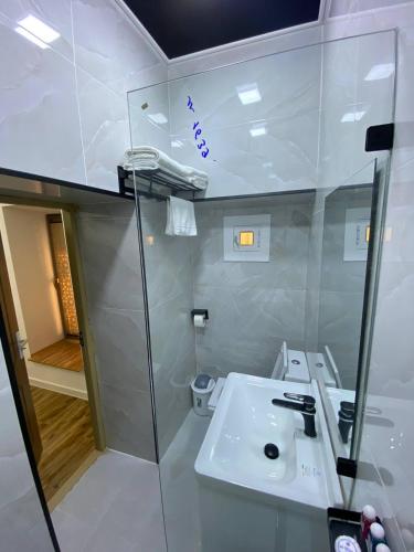 a bathroom with a sink and a glass shower at Mukhlisabegim Hotel in Bukhara
