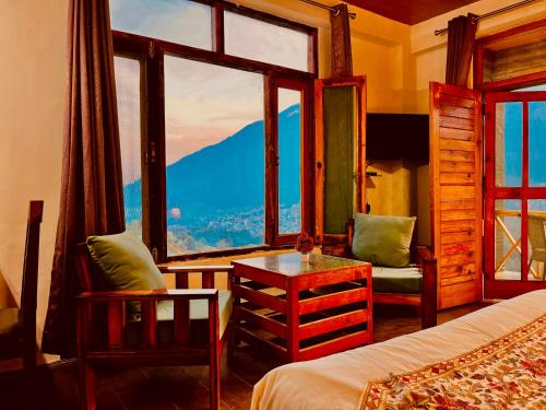 a bedroom with a bed and a view of a mountain at Naina Spring Resort, Manali - away from city hustle in Manāli