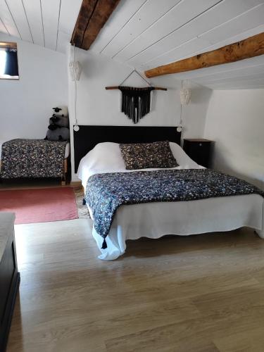 a bedroom with two beds in a room at Le logis d'Hestia in Billom