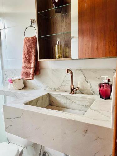 a bathroom counter with a sink and a mirror at Chalé Cantinho da Paz in Santa Teresa