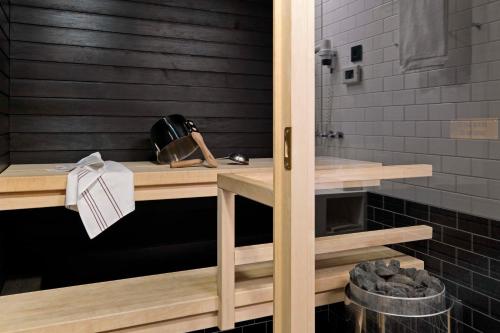 a bathroom with a wooden table and a shower at Scandic Paasi in Helsinki