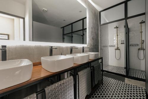 a bathroom with three sinks and a shower at Bed in mixed room Hippie Nice in Mexico City