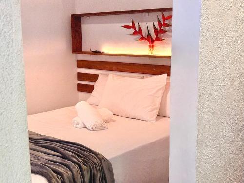 a small bedroom with a bed with a mirror at Recanto Serenare in Angra dos Reis