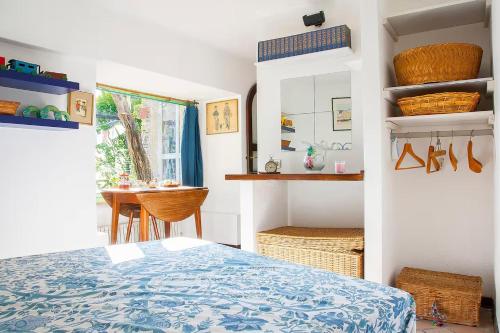 a bedroom with a bed and a table and a window at Tra Mare e Luna in Zoagli
