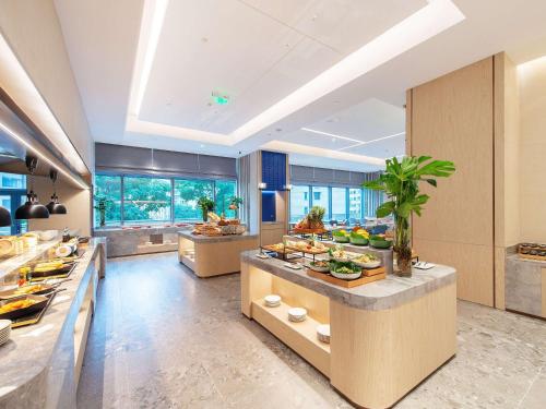 a large kitchen with a lot of food on a counter at Novotel Wuxi in Wuxi