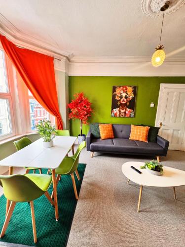 a living room with a couch and a table at Best Offer Spacious and Chic 2 Bed Apartment in Plymouth