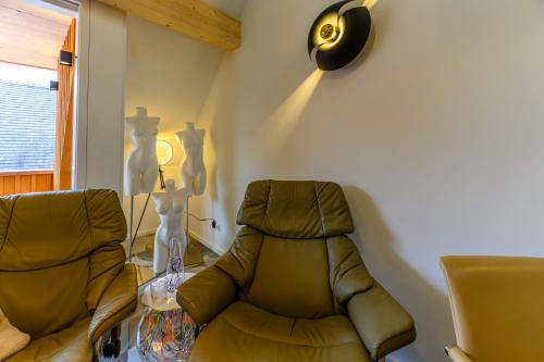 a living room with a chair and a table at Hotel-Restaurant Kostbar in Engen