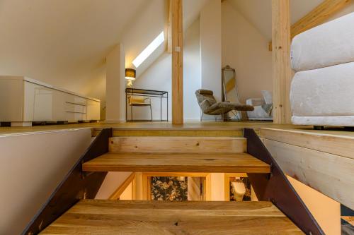a room with wooden stairs and a large window at Hotel-Restaurant Kostbar in Engen