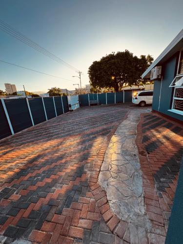 a brick driveway in front of a building at Kitty Guest House in Bellville