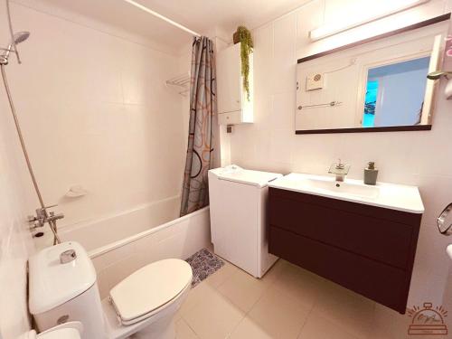 a white bathroom with a toilet and a sink at Maena San Maurici Lago in Empuriabrava