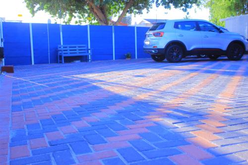 a white suv parked in a parking lot at Kitty Guest House in Bellville