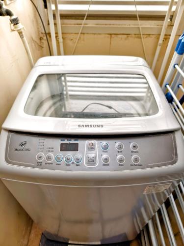 a toaster oven sitting on a shelf in a room at 2412T2 Avida Towers Cebu IT Park 1BR Unit Queen Bed in Cebu City